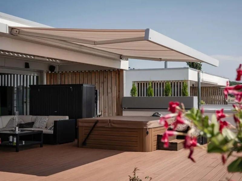 CAMABOX retractable awning system extended over patio
