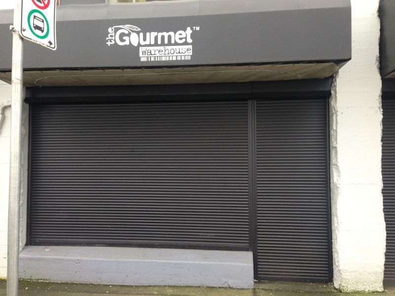 Aluminum security shutter protecting a retail storefront after hours