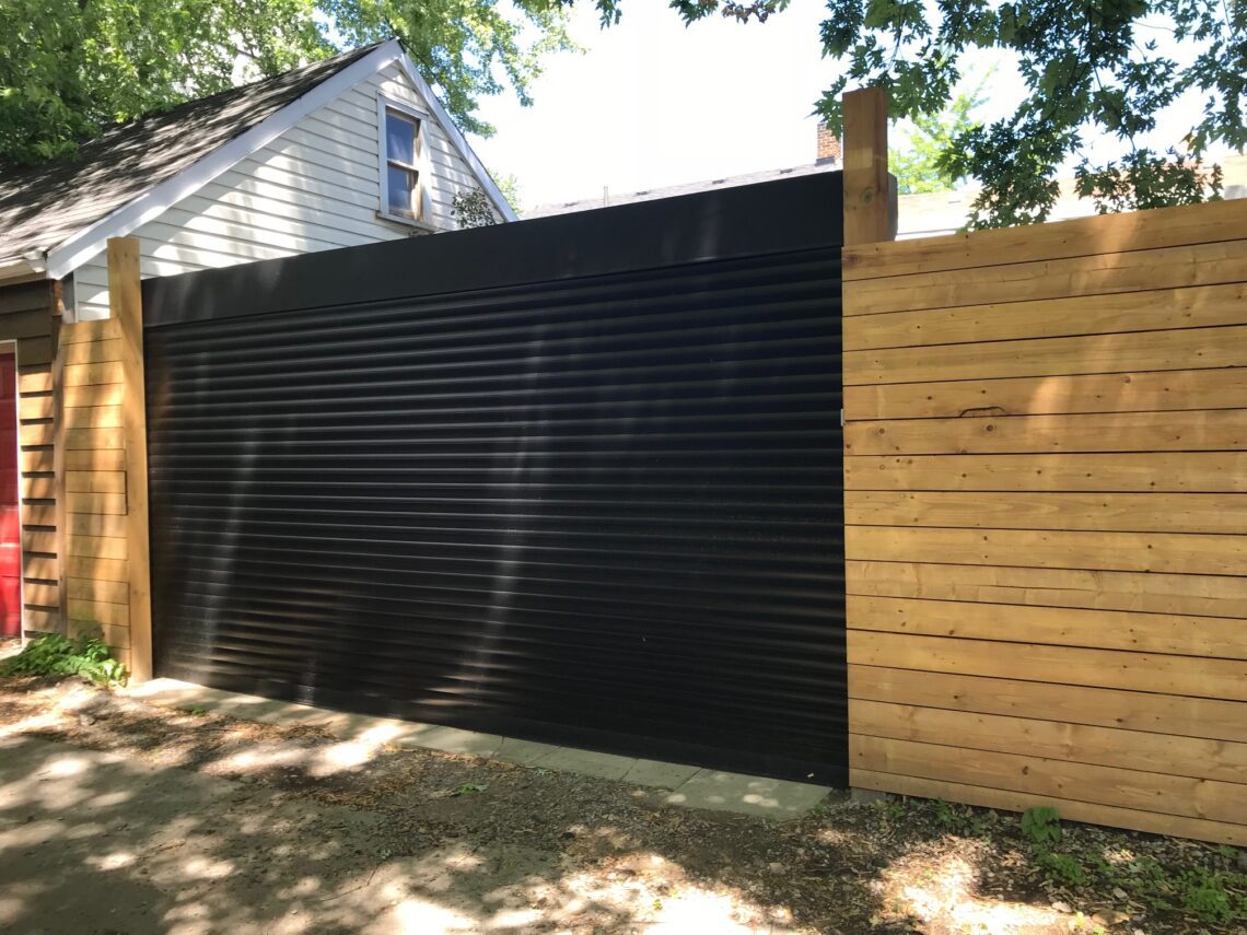 Laneway roll-up shutter on a wood-framed garage opening