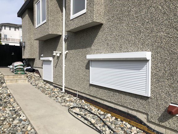 Roll-up security shutter on a ground-floor basement window