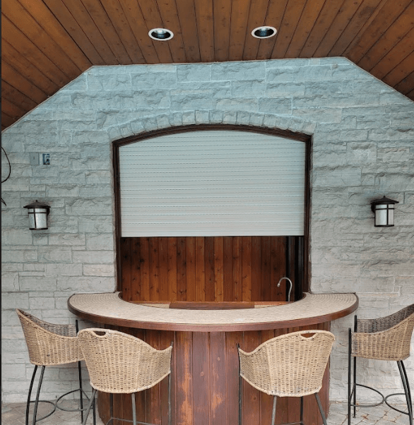 Roll-up shutter open on a cabana bar window for outdoor serving