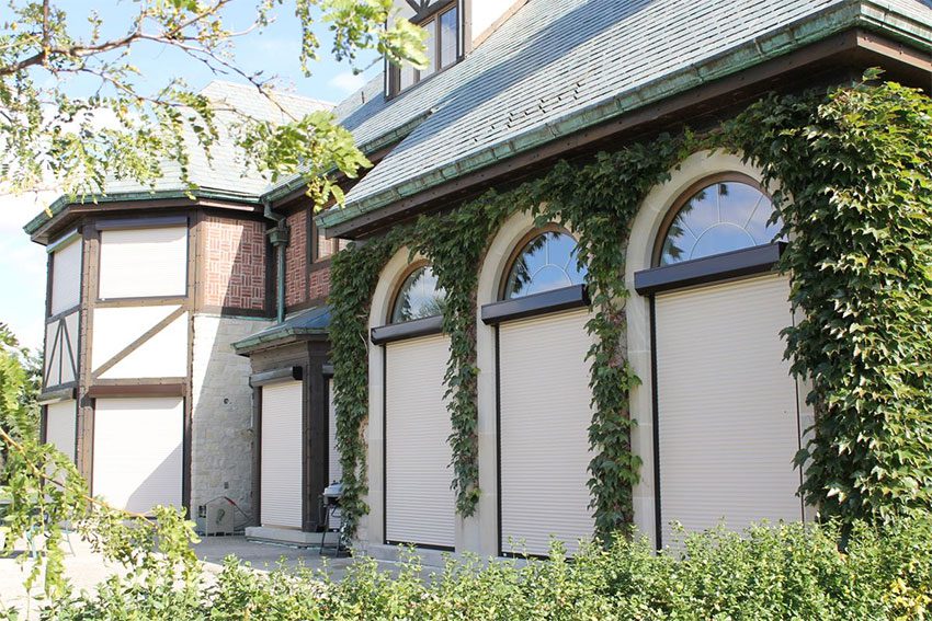 Roll-up garage door on an ivy-covered residential garage