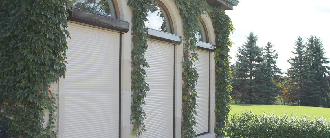 Cream-coloured roll-up security shutters on residential windows