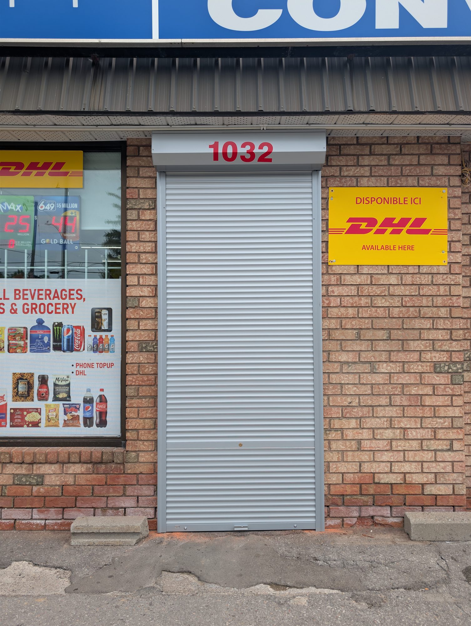 Grey roll-up security shutter on a storefront door