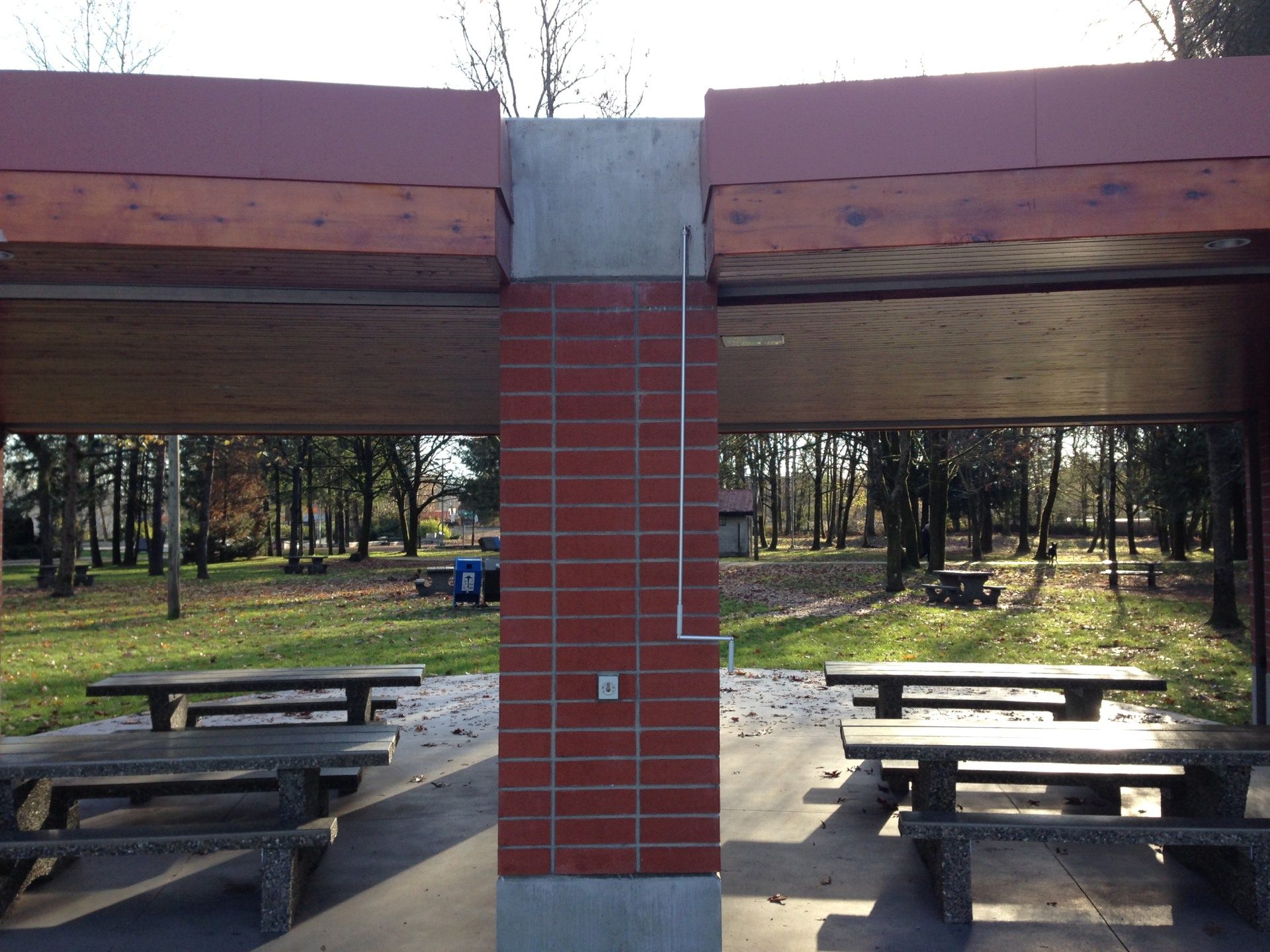 Underside of a park picnic shelter with the storage bay shutters retracted into housings above the roof beams