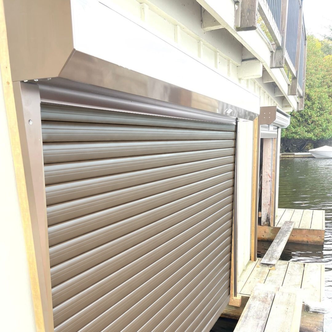 Illustration of the same boathouse bay with the bronze roll-up door closed
