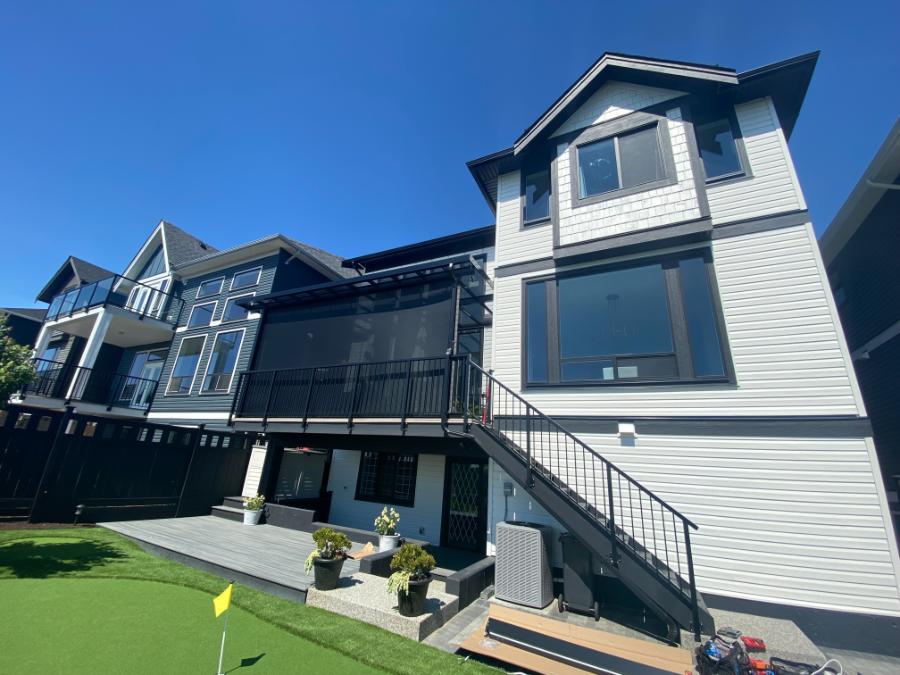 Retractable privacy screen installed on covered deck