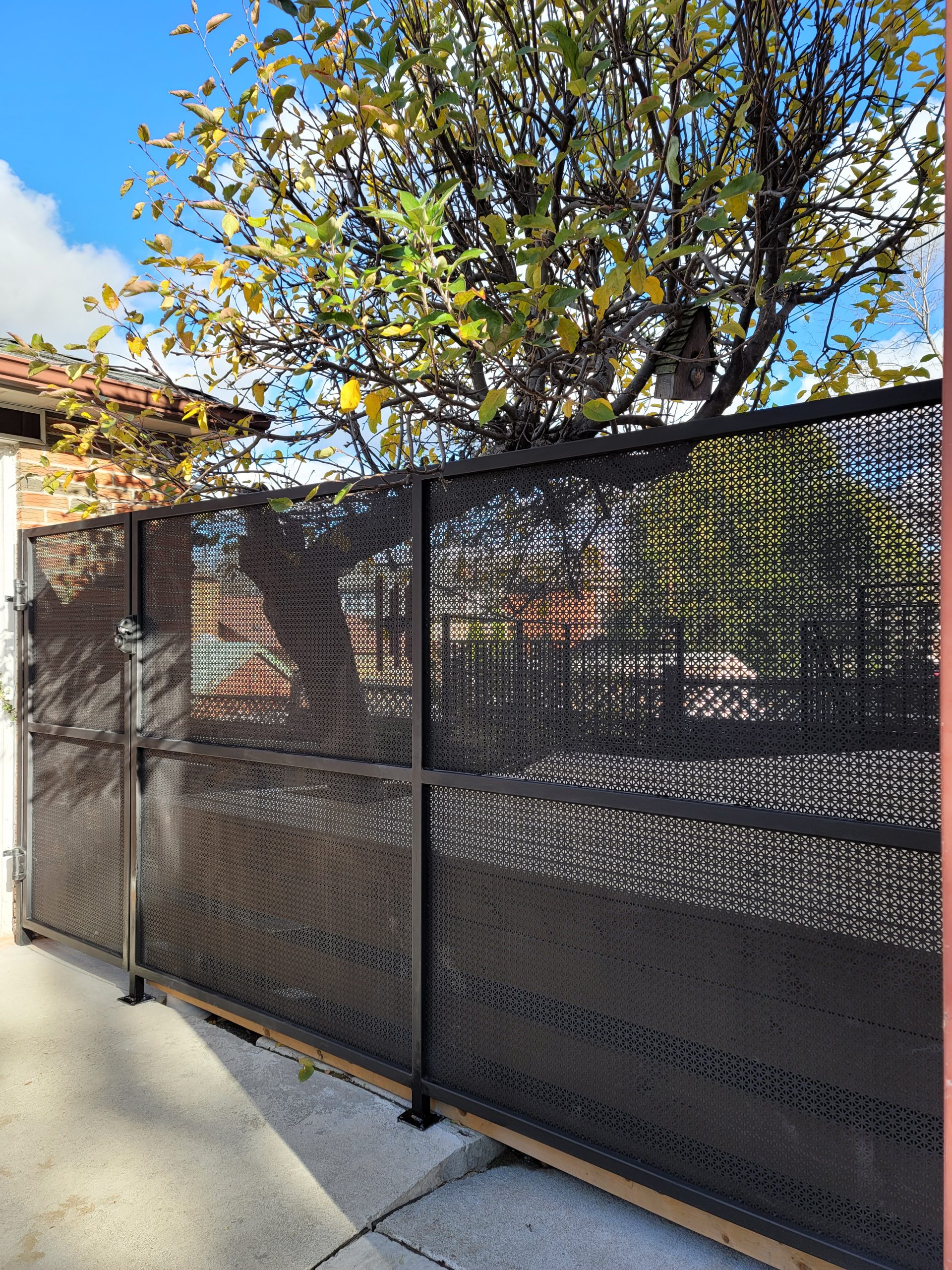 Dark-framed rigid privacy screens installed along a balcony edge