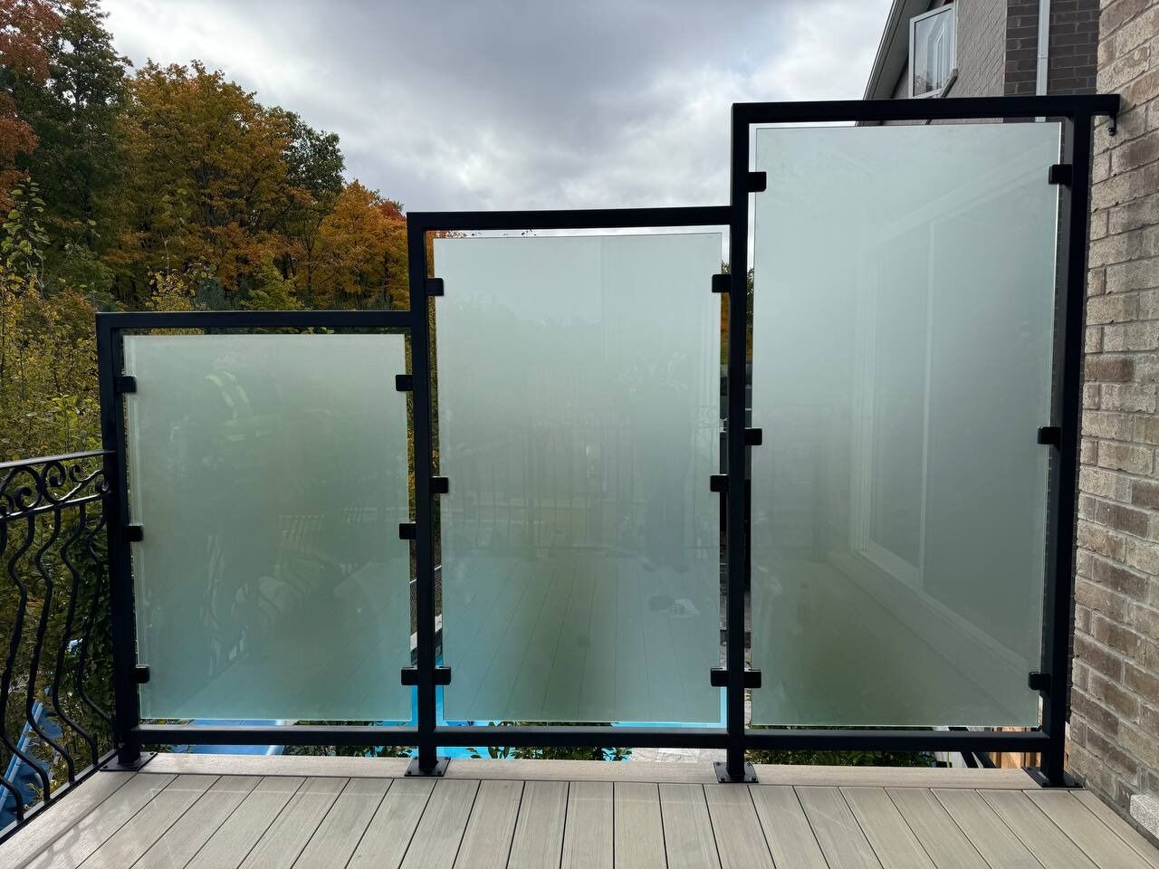 Tall metal-framed privacy screens installed on an elevated balcony
