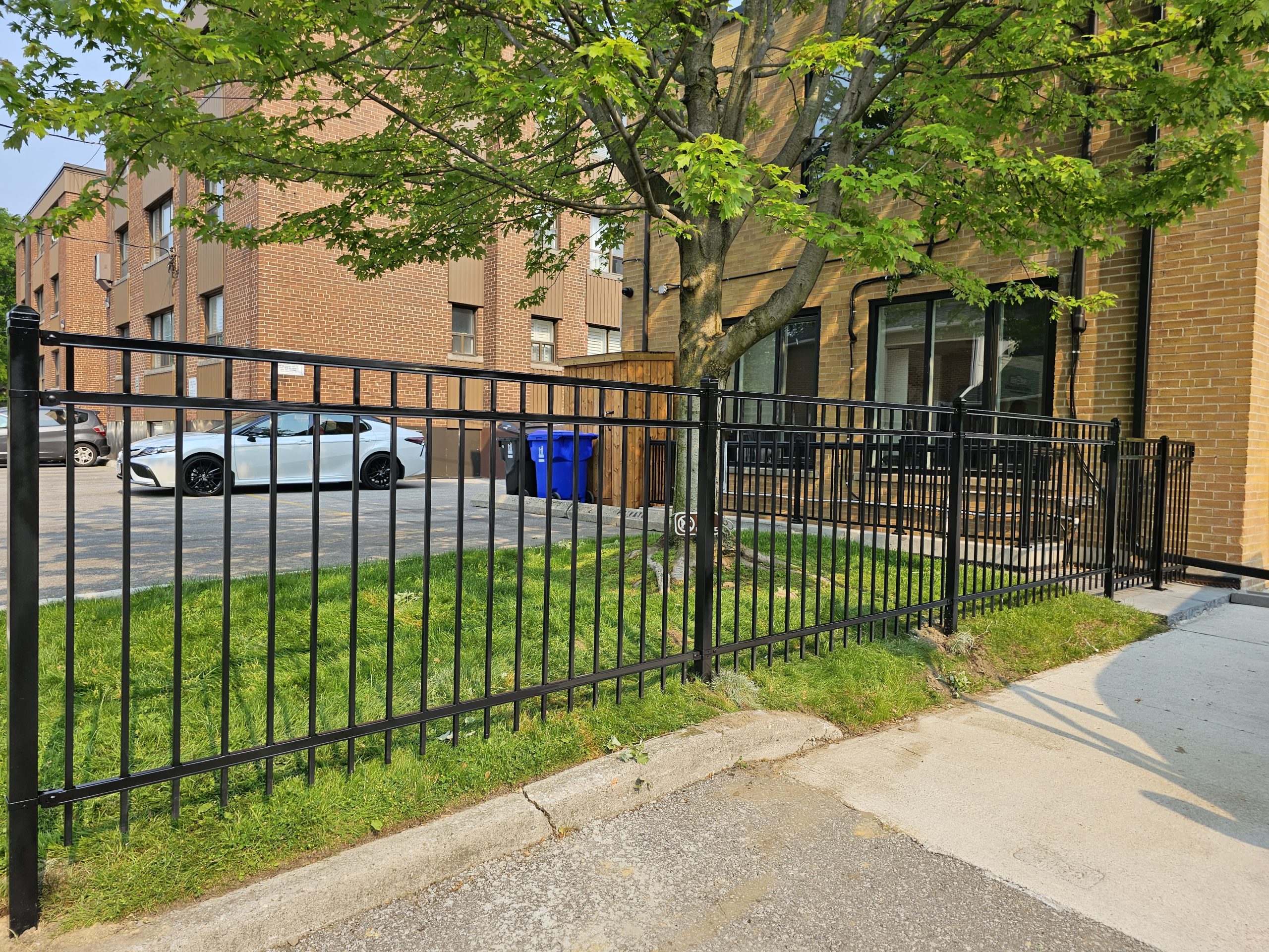 Row of black metal equipment enclosures protecting outdoor mechanical assets