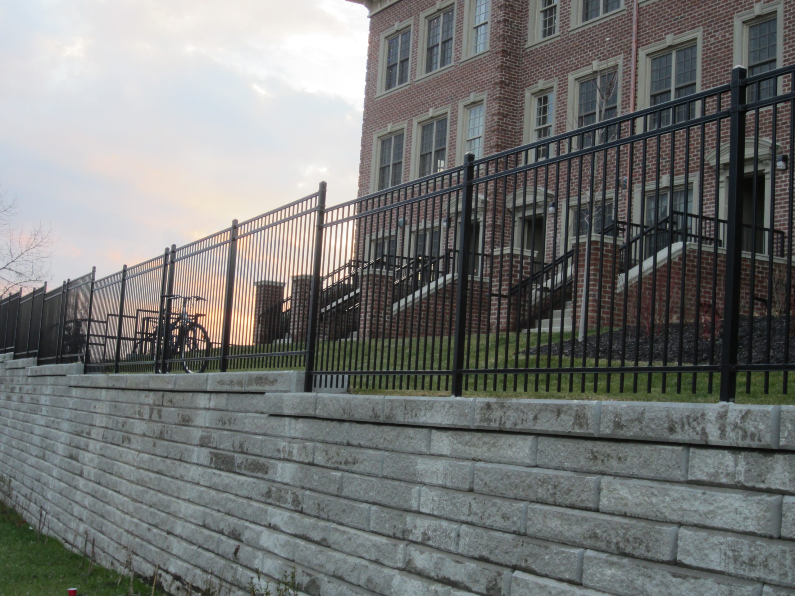 Black louvered metal enclosure surrounding exterior mechanical equipment