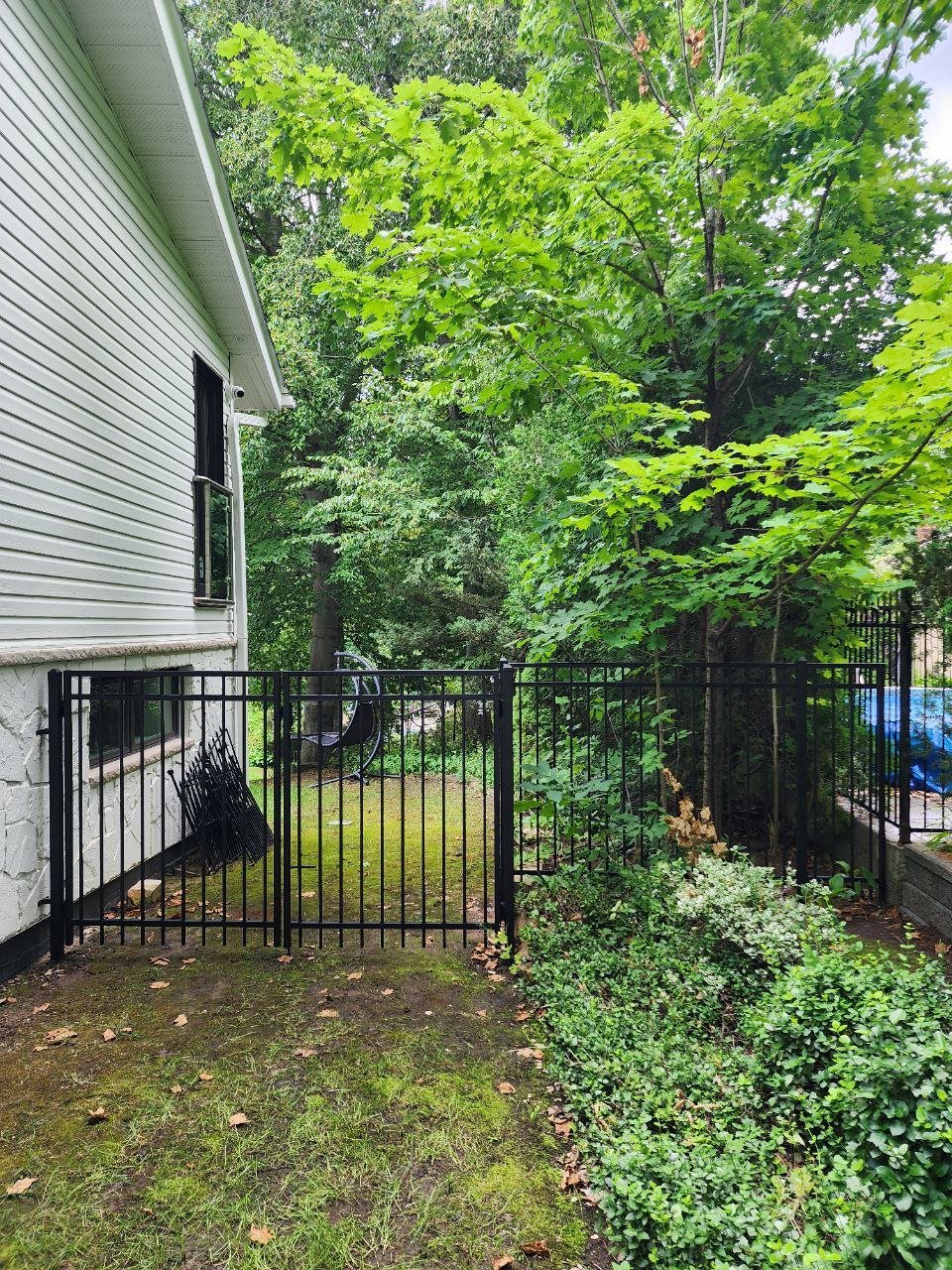 Black screened equipment enclosure installed beside an exterior wall