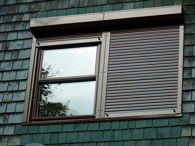 Two window shutters one open one closed