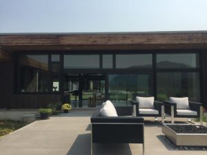 Roll up retractable screen installed on a modern home patio for shade and privacy.