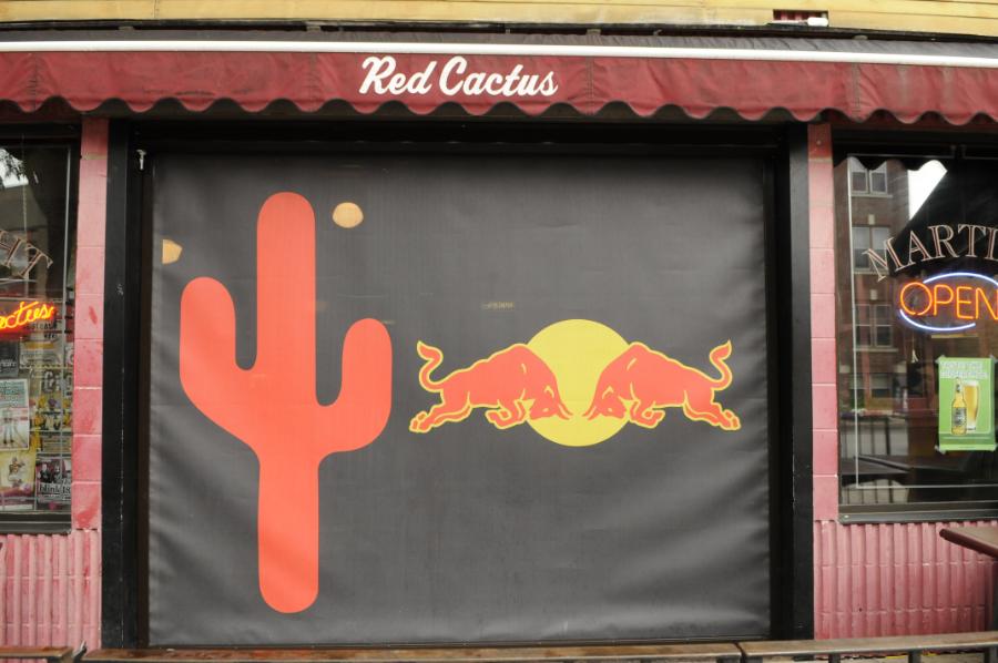 Roll up retractable screen lowered over a storefront entrance at Red Cactus.