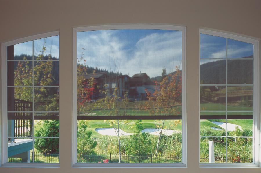 Roll up retractable screens installed on large windows overlooking a golf course.